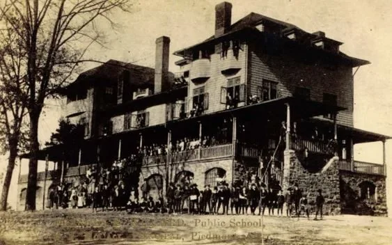 Students filling the porches and lawn of the Public School, Piedmont
