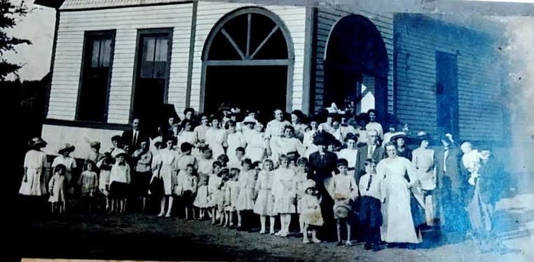 A crowd in Sunday dress gathered outside the Cumberland Presbyterian Church