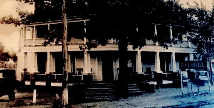 Rocking chairs and columns along the shaded Dixie Hotel porch