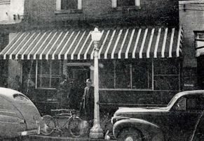 The Farmers and Merchants Bank storefront with a striped awning