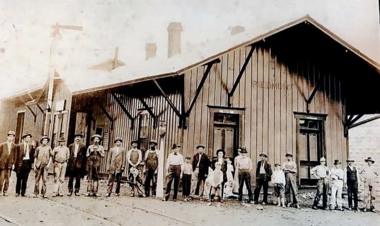 Railroad workers lined up outside the wooden Piedmont depot