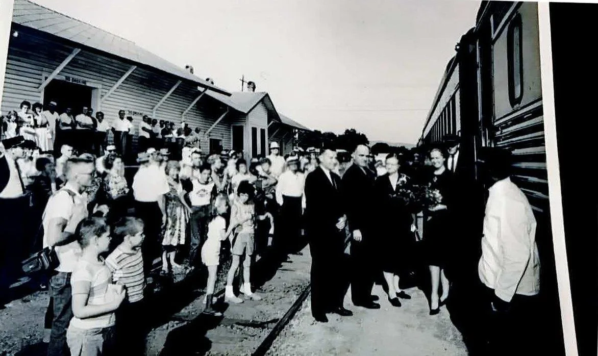 A crowd of families gathered beside a passenger train at the Seaboard depot